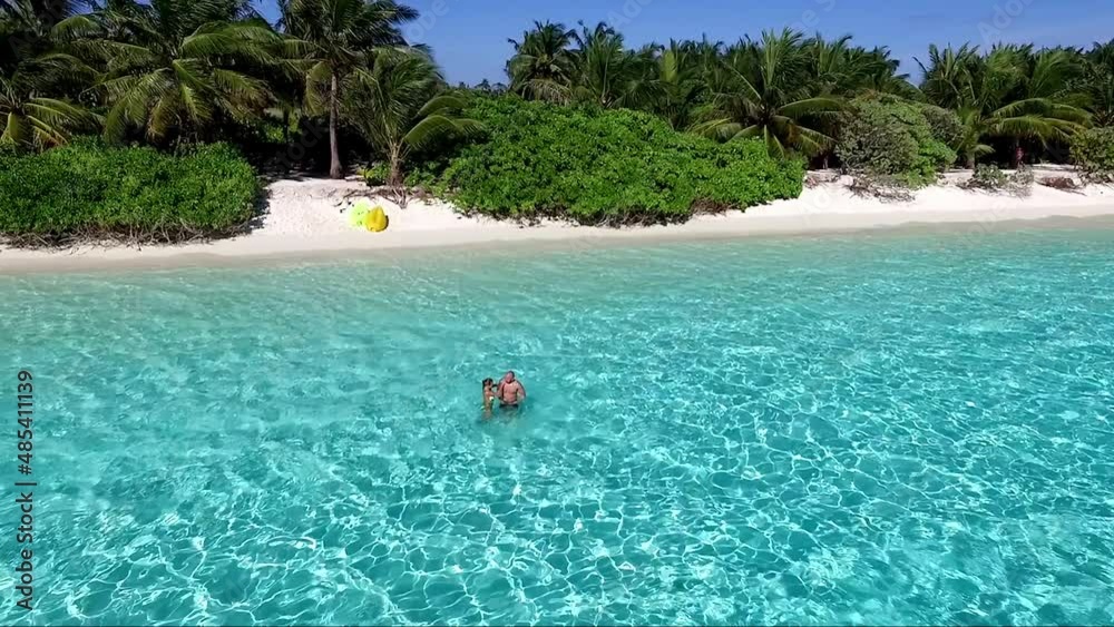 Сouple in love swimming in the indian ocean Maldives. Honeymoon. Man and woman lying in a hammock. Flight with drone UHD Сouple in love swimming in the indian ocean Maldives. Honeymoon. Man and woman lying in a hammock. Flight with drone UHD