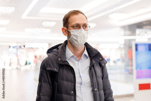 Caucasian man wearing face mask in mall