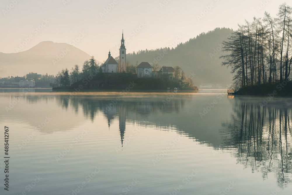 Beautiful view to Lake Bled, the most famous Slovenian lake and island Bled with Pilgrimage Church of the Assumption of Maria at dawn