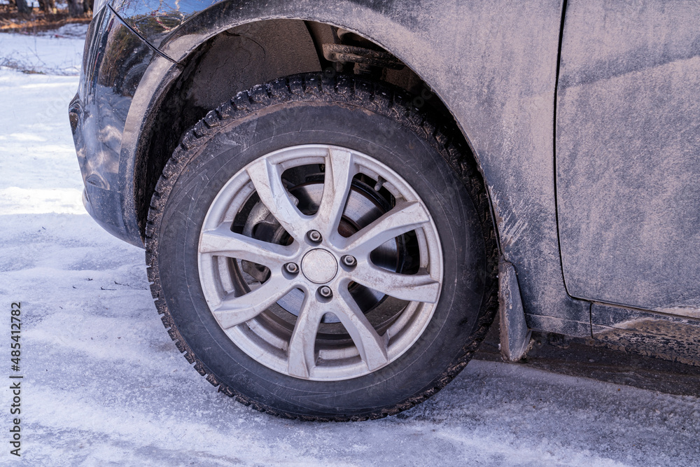 a car wheel with spikes in the snow