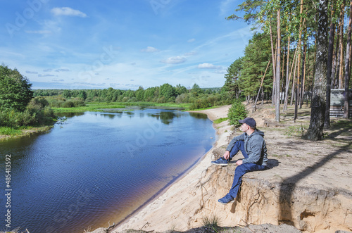 Man relax on the river bank. © alexey351