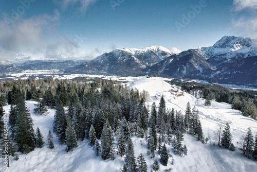 Karwendel - winter landscape with snow covered mountains, forest and clouds in the sky
