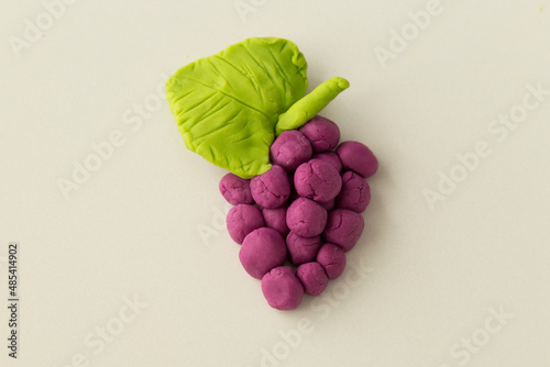 Making grape game step by step with dough for children's activity in the school art lesson and plasticine concept.