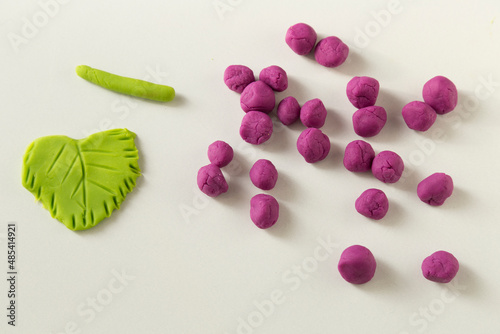 Making grape game step by step with dough for children's activity in the school art lesson and plasticine concept.
