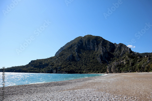 pebble beach of Cirali  Turkey and mediterranean sea with mountain and clouds in spring sunny day