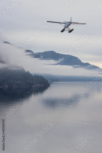 Seaplane flying over Canadian Mountain Nature Landscape on the Pacific West Coast. Cloudy and fog Winter Day. 3d Rendering Airplane Adventure Concept. Howe Sound, British Columbia, Canada.