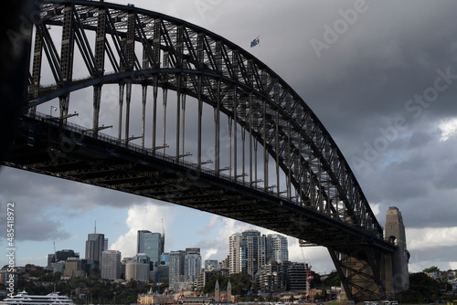 View of Sydney Harbour Bridge from the city to McMahons Point, Sydney, Australia. Scene shows Lunar Park, North Sydney Central Business District, cranes, cruise boat © A Shot of Bliss