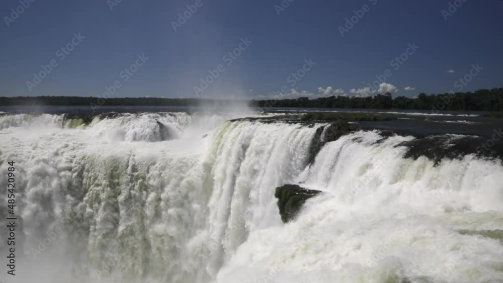 Tourism. View of the Iguazu waterfalls in Iguazu national park, Misiones, Argentina. Slow motion shot of the falling water powerful texture and pattern. Tourism. View of the Iguazu waterfalls in Iguazu national park, Misiones, Argentina. Slow motion shot of the falling water powerful texture and pattern.