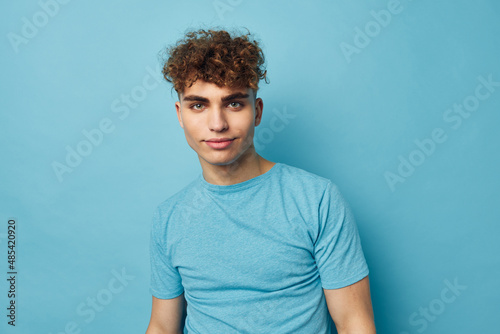 Attractive man in blue t-shirts with a pumped-up body blue background