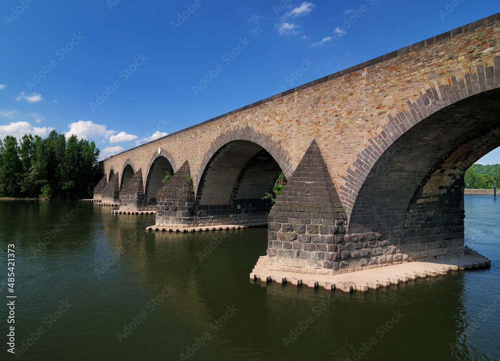 UNESCO Heritage Balduin Bridge On Mosel River Germany On A Beautiful Sunny Summer Day With A Clear Blue Sky And A Few Clouds