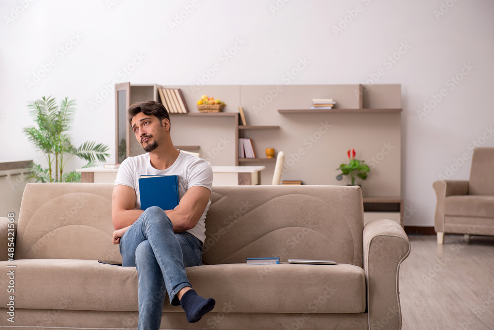 Young male student studying at home during pandemic Young male student studying at home during pandemic
