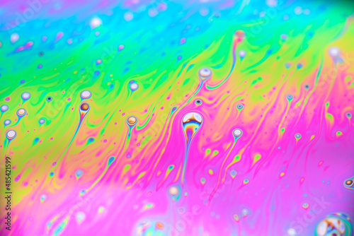Soap bubbles with colored patterns on the surface in macro. Details and reflections on the soap bubbles in close-up.