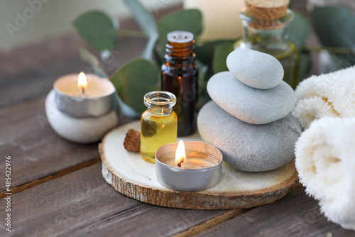 Assortment of natural oils in glass bottles on wooden background. Concept of pure organic ingredients in cosmetology. Bath accessories, atmosphere of harmony, relax. Close up macro. Healthy lifestyle