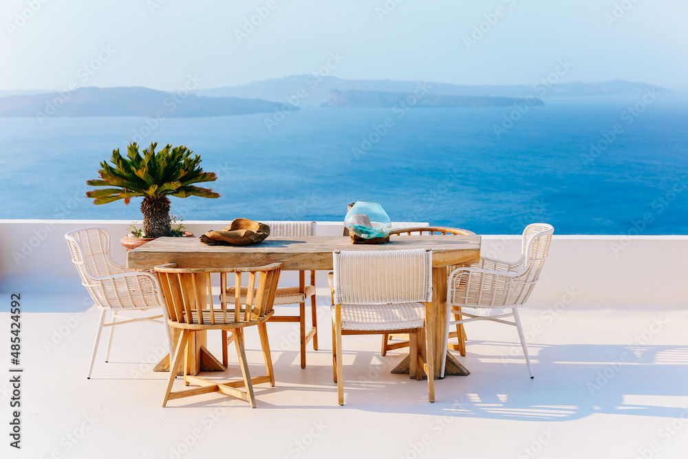 Table and seats at balcony in Oia in Santorini with great view