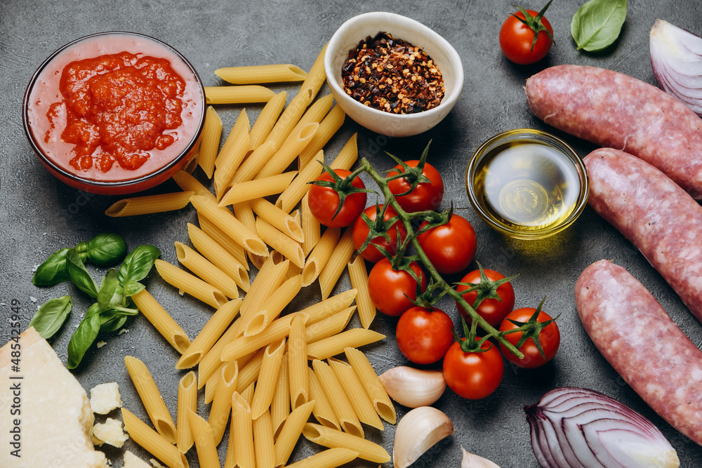 Typical Italian food Pasta spaghetti, parmesan cheese, olive oil, spices, basil, tomato sauce and fresh tomatoes. top view Typical Italian food Pasta spaghetti, parmesan cheese, olive oil, spices, basil, tomato sauce and fresh tomatoes. top view