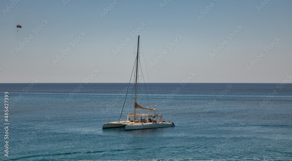 Catamaran in turquoise lagoon of the coast of Cyprus. Catamaran in turquoise lagoon of the coast of Cyprus.