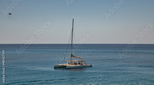 Catamaran in turquoise lagoon of the coast of Cyprus.