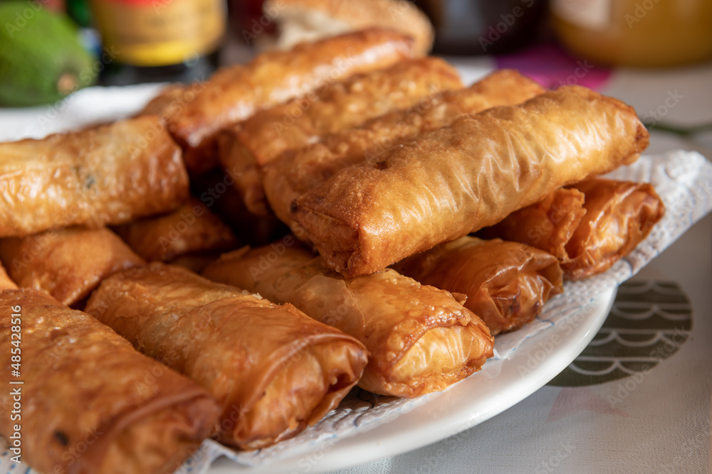 A full plate of fried golden, crispy spring rolls. A full plate of fried golden, crispy spring rolls.