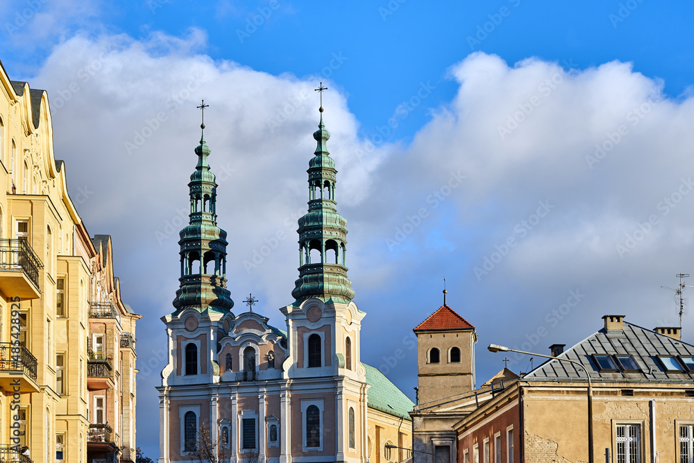 Fototapeta premium Historic tenement houses and bell towers of a baroque church
