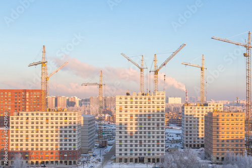 Construction of apartment buildings in new Moscow, cranes, skyscraper towers in winter
