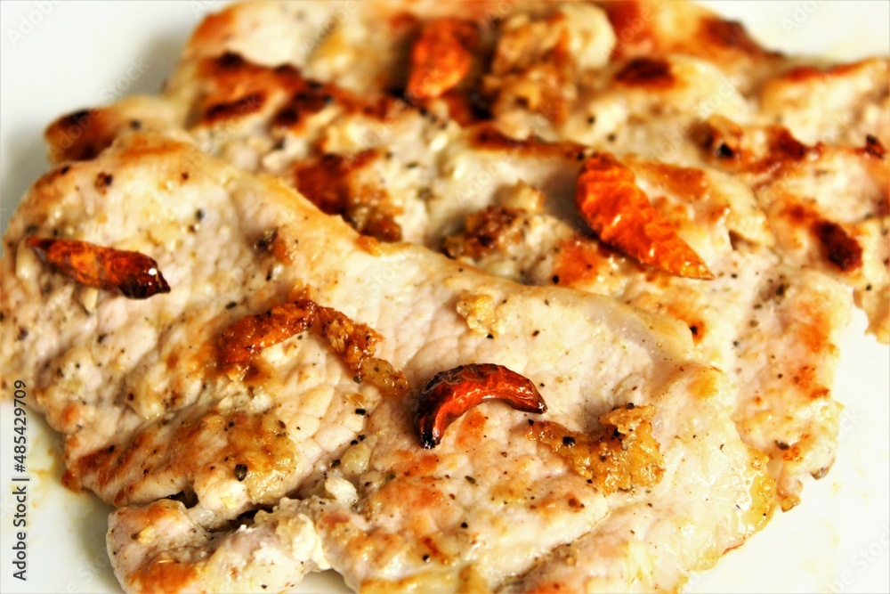 Grilled slices pork with red chili pepper. close up photo top view Grilled slices pork with red chili pepper. close up photo top view