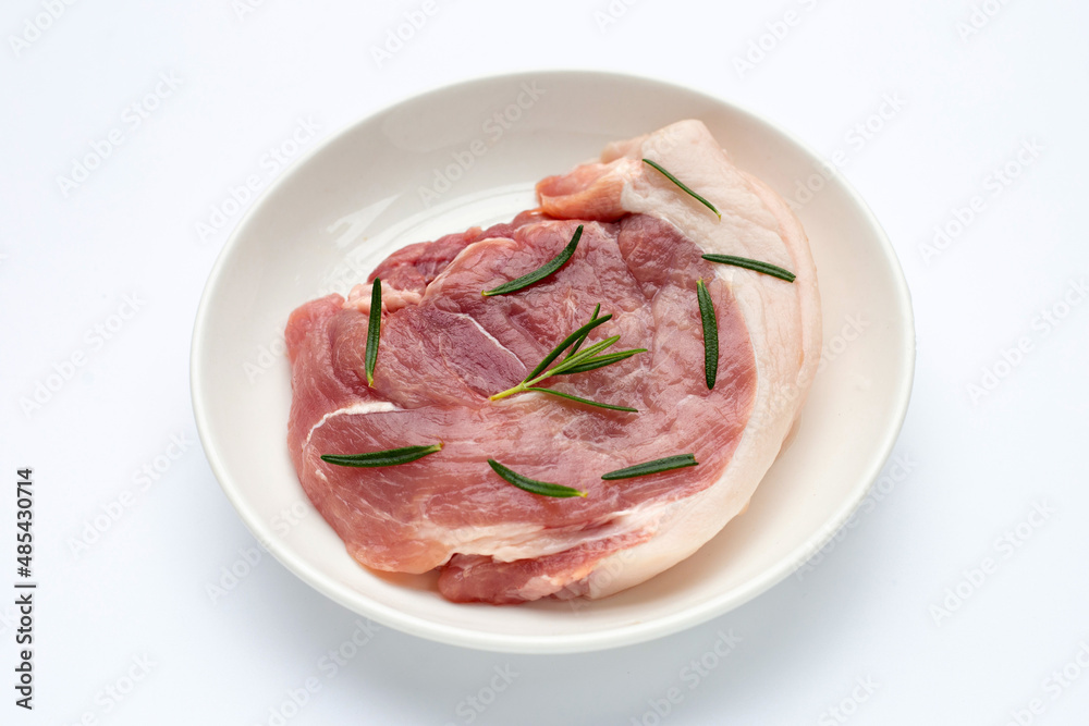 Pork meat in plate on white background.