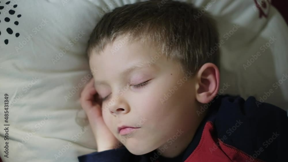 a five-year-old boy sleeps in his crib a five-year-old boy sleeps in his crib