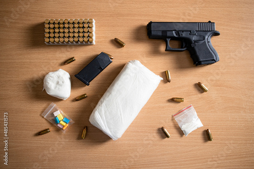 Drugs paraphernalia, gun, bullets and cocain narcotics packaging ready for street distribution.