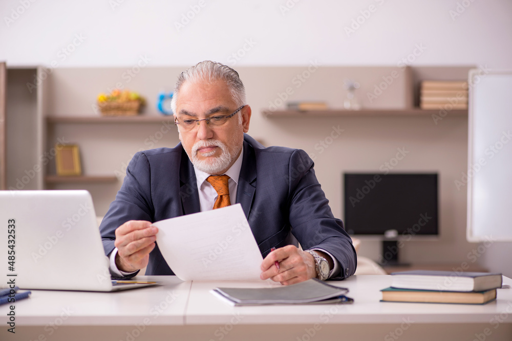 Old male employee working from home during pandemic Old male employee working from home during pandemic
