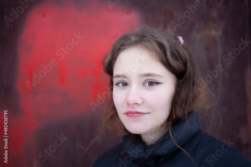 Girl with bright lipstick. Portrait of a teenager. Beautiful girl looking at the camera and smiling. Life style of a young lady.