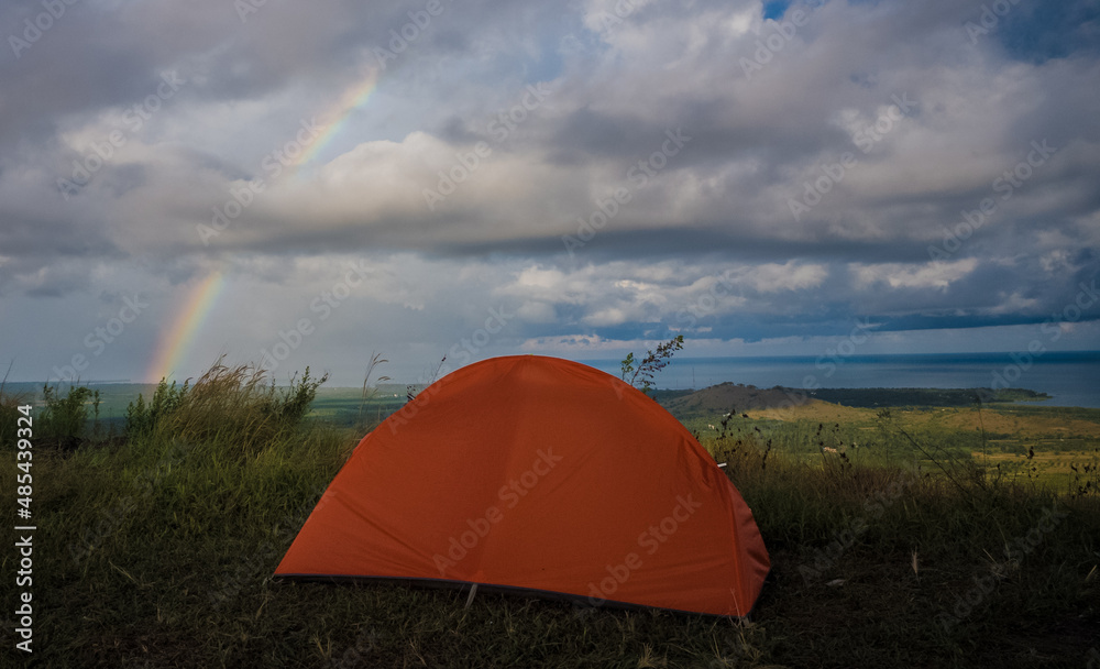 A small tent on the hill at night