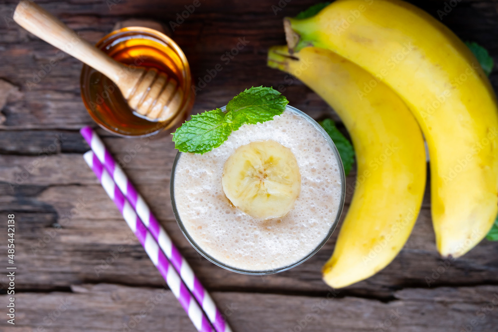 Banana fresh cocktail vanilla smoothies fruit juice beverage healthy the taste yummy in glass drink episode good morning on wooden background from the top view. Banana fresh cocktail vanilla smoothies fruit juice beverage healthy the taste yummy in glass drink episode good morning on wooden background from the top view.