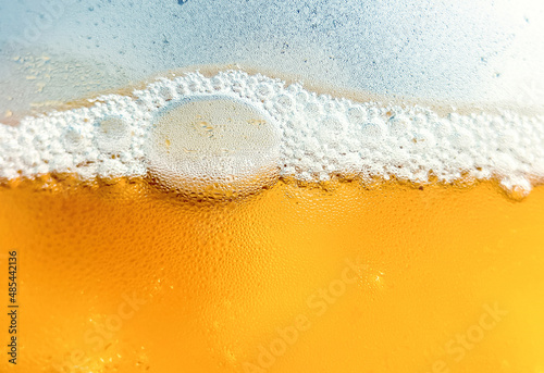 Glass with cold drink beer with condensation ice cool beverage background