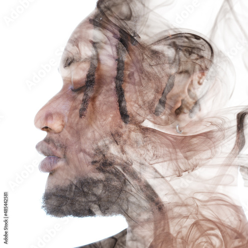 A portrait of a man dissolving into smoke. Double exposure.