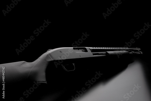 Photography Pump-action 12 gauge shotgun isolated on a white back