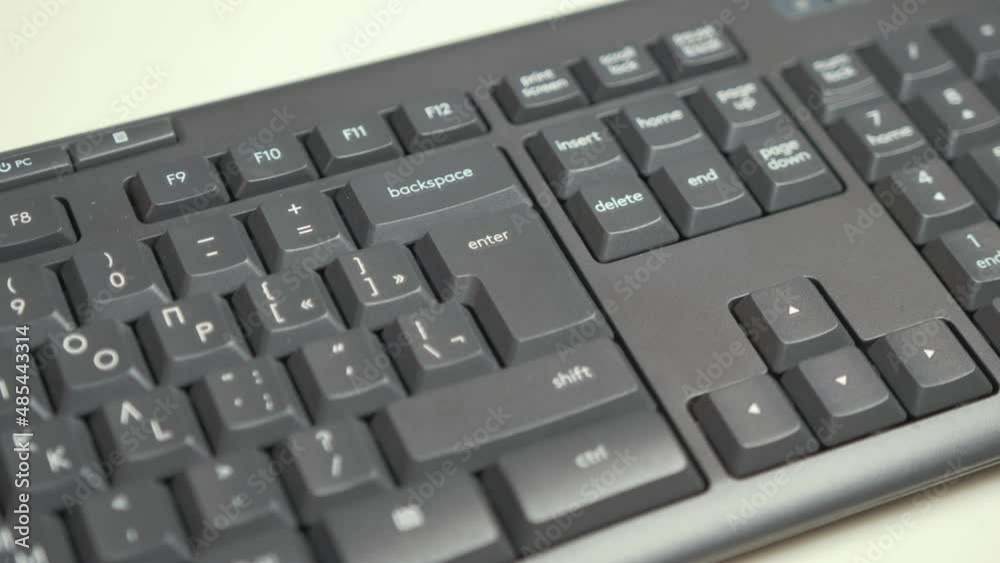 Pressing 'Enter' key on black keyboard. Medium Shot Pressing 'Enter' key on black keyboard. Medium Shot