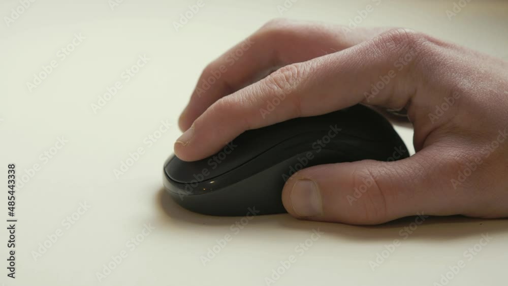Man's hand using small wireless computer mouse Man's hand using small wireless computer mouse