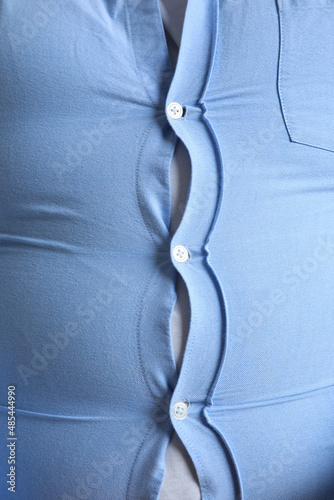 Bild auf Leinwand Closeup view of overweight man in tight shirt as background
