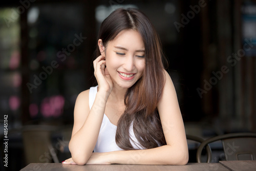 Beautiful Asian girl sitting in the old restaurant waiting for order