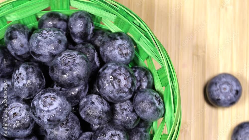Fresh juicy blueberries in a basket, rotation backgound. Close up. Loop motion