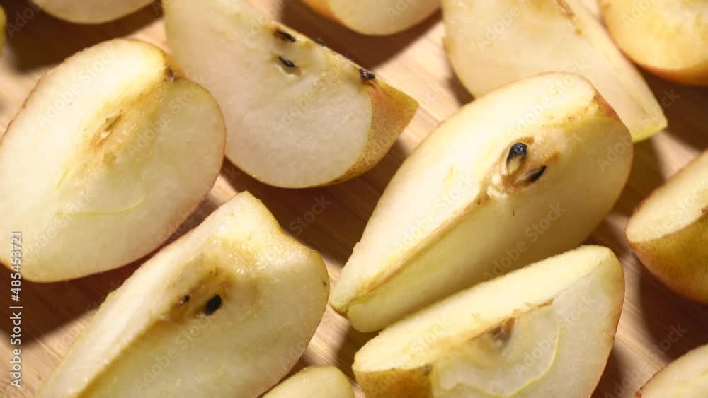 Sliced pears rotation on a wood cutting board. Loop motion Sliced pears rotation on a wood cutting board. Loop motion