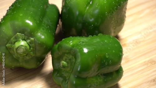 Fresh wet green bell peppers close up rotation