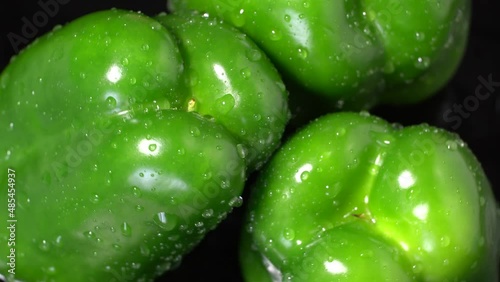 Fresh wet green bell peppers close up rotation