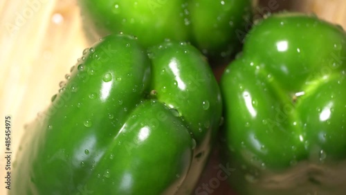 Fresh wet green bell peppers close up rotation