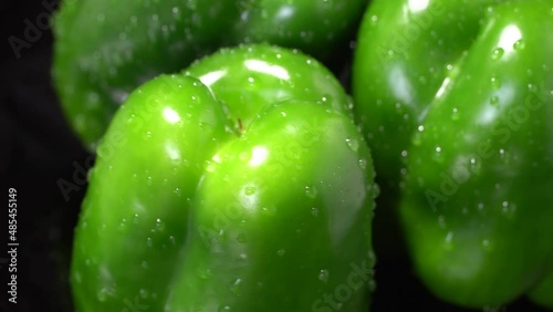 Fresh wet green bell peppers close up rotation