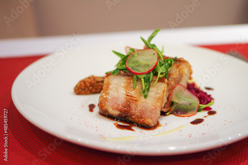 Schilderij op canvas Sliced crispy roasted pork belly with sauce on white plate at asia fusion dish r