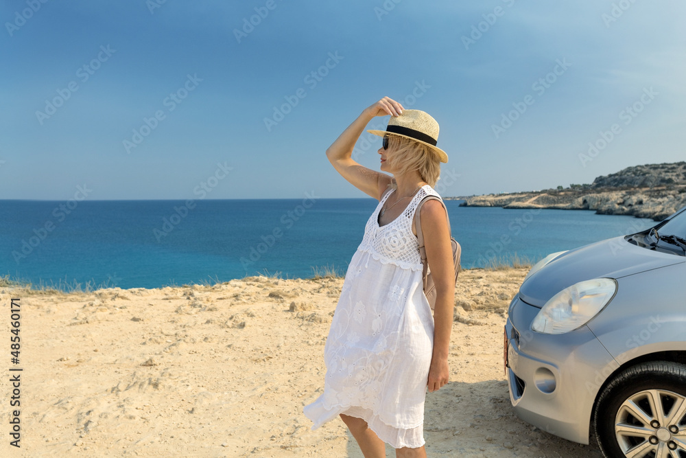 View of mature woman traveler looking at sea, coast of Cyprus. Summer vacation on the car. Freedom concept. View of mature woman traveler looking at sea, coast of Cyprus. Summer vacation on the car. Freedom concept.