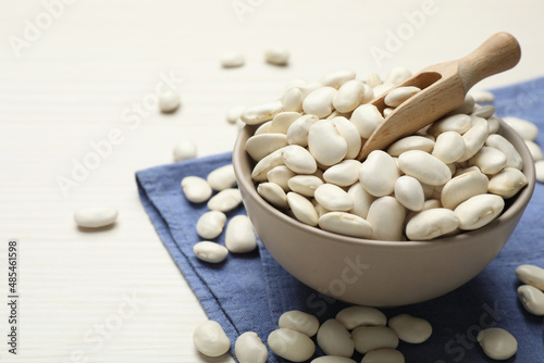 Raw beans on white wooden table, closeup. Space for text