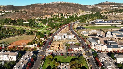 Drone backward moving shot over San Elijo Hills town center in San Marcos, California ,USA with the hilly terrain in the background