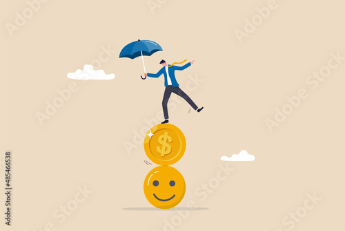 Balance between money and happiness, wealth and health, choosing meaningful life and real success concept, businessman holding umbrella balancing himself on stack of smile face and dollar coin.